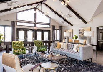 A living room with couches and chairs and a rug